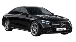 Black Mercedes-Benz E-Class shown from the front three-quarter view with a Blacklux plate
