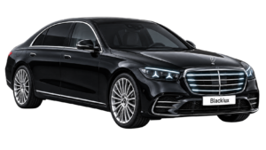 Black Mercedes-Benz S-Class shown from the front three-quarter view with a Blacklux plate